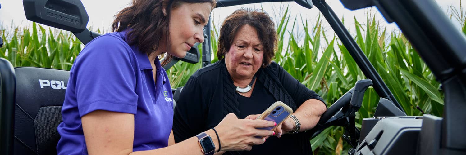 a women and an ADM rep looking at an iPhone