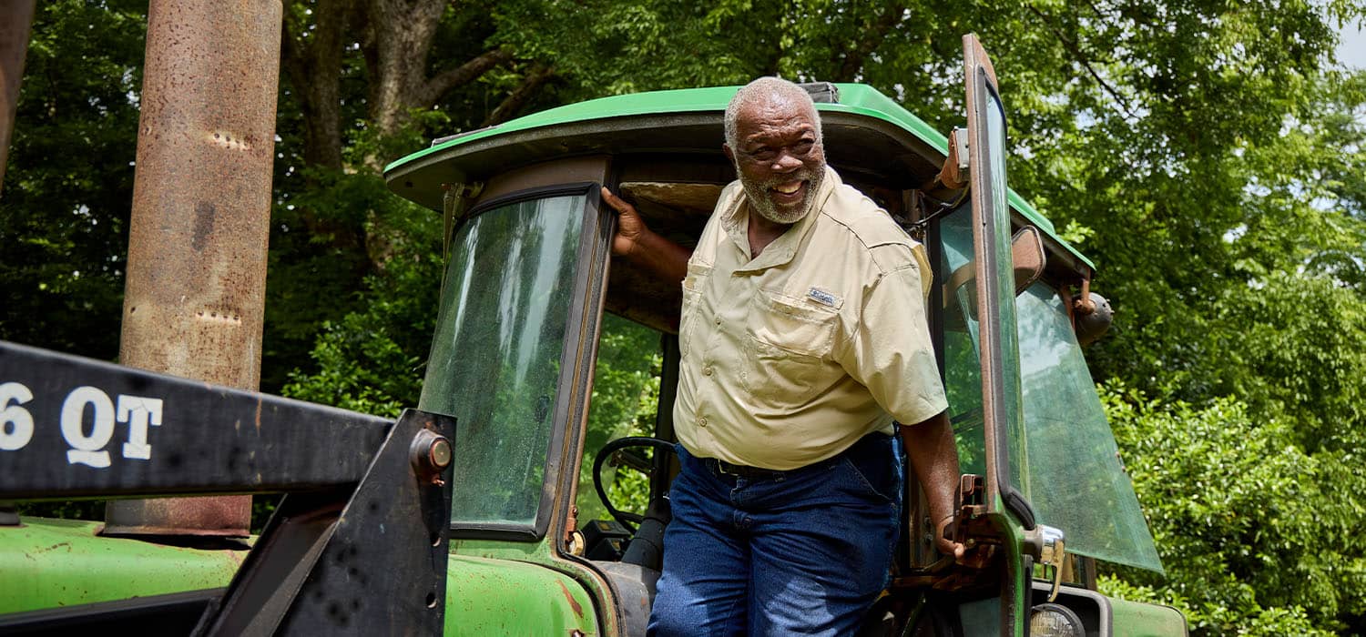 Producer, Howard Hodge stepping out of a tractor