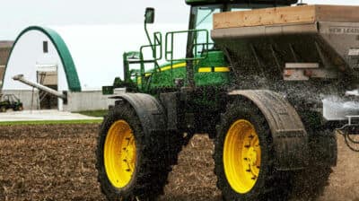 tractor applying fertilizer on farm field
