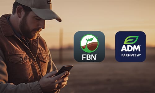 man with a hat looking at his phone. FBN and ADM Farmview app icons are to the right of him.