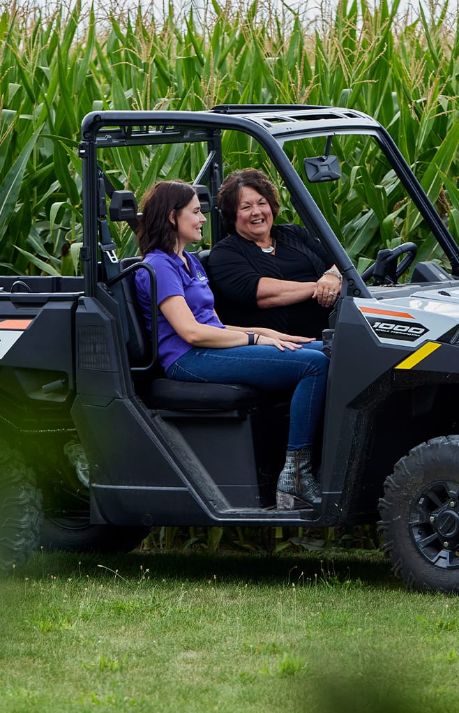 Producer and ADM rep sitting in a tractor in conversation